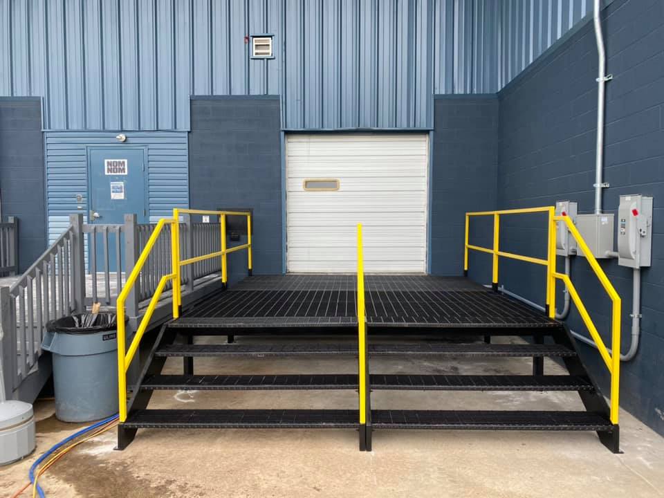 A loading dock with steps and railing.